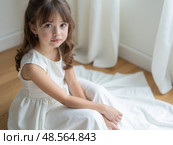 Girl in a chic long dress sitting on the floor. White wedding dress on the bride's body. Beautiful light dress with a long hem, a portrait of a fragile delicate girl before the wed. Стоковое AI-изображение, AI-художник Sergey Grishin / Фотобанк Лори