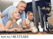 Experienced teacher of computer class assisting enthusiastic woman. Стоковое фото, фотограф Яков Филимонов / Фотобанк Лори