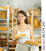 Portrait of a young girl with a bocadillo in her hands in the interior of private bakery. Стоковое фото, фотограф Яков Филимонов / Фотобанк Лори