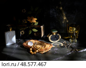 Still life with beads, perfume, lacquered cabinet and glasses. Стоковое фото, фотограф Сергей Фролов / Фотобанк Лори