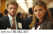 Two professionals participate in a networking event, engaging with other attendees in a lively business conference atmosphere. Стоковое AI-изображение, AI-художник Данила Большаков / Фотобанк Лори