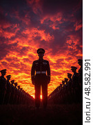 Soldiers lined up in formation face a striking sunset, embodying unity and commitment at a training base during evening hours. Стоковое AI-изображение, AI-художник Данила Большаков / Фотобанк Лори