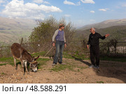 Men are talking with each other. View of the mountains in Armenia. Village in Tavush region. Редакционное фото, фотограф Evgenia Shevardina / Фотобанк Лори