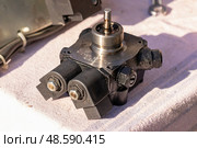 Repair of a large boiler gas burner, analysis of parts on the table: SUNTEC fuel pump (2019 год). Редакционное фото, фотограф ok_fotoday / Фотобанк Лори