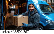 A delivery worker holds a cardboard box while standing next to a blue van on a snowy city street bustling with people. Стоковое AI-изображение, AI-художник Данила Большаков / Фотобанк Лори