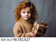 Little Wonder: A Girl Embraces the Mystery of a Brown Gift Box. Стоковое AI-изображение, AI-художник Данила Большаков / Фотобанк Лори