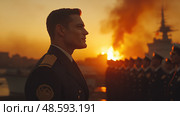 A naval officer maintains a strong stance during an evening ceremony with a burning horizon and a line of uniformed soldiers behind him. Стоковое AI-изображение, AI-художник Данила Большаков / Фотобанк Лори