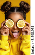 A woman is holding a lemon in each hand and making a face. Стоковое AI-изображение, AI-художник Ярославский Максим / Фотобанк Лори