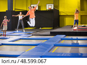 Teen girl jumping on trampoline on indoor inflatable playground. Стоковое фото, фотограф Яков Филимонов / Фотобанк Лори