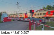 Saint-Petersburg, Russia - Aug 17 2022, 4k, Closed railway crossing waiting for the passing train "Lastochka", Saint-Petersburg, Russia. Редакционное видео, видеограф Сергей Богомяко / Фотобанк Лори