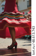 A close-up of a dancer's feet in traditional Mexican huaraches, mid-step during a folkloric dance performance. The vibrant skirt waving on air. Стоковое AI-видео, аниматор Sergey Grishin / Фотобанк Лори