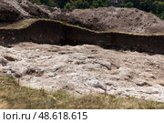 Archaeological excavation site with exposed soil layers and chalky terrain. Стоковое фото, фотограф Mariana Rusanovschi / Фотобанк Лори