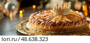 Galette des rois or king cake. Traditional cake baked at Epiphany, celebration of the Twelfth Night after Christmas. Almond flaky pastry cake. Freshly baked homemade three king bread with a crown. Стоковое AI-изображение, AI-художник Марина Демидюк / Фотобанк Лори