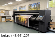 Printing large format images in a professional studio with specialized equipment. Стоковое AI-изображение, AI-художник Александр Довянский / Фотобанк Лори