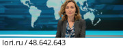 The news anchor discusses global events, poised in a contemporary studio setting while a world map highlights key regions. Стоковое AI-изображение, AI-художник Данила Большаков / Фотобанк Лори
