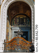 Fragments of facade decor with stucco and mosaics of the St. Nicholas Cathedral in Kronstadt. Main entrance, bars decorated with St. George's ribbons. Стоковое фото, фотограф Оксана Медведева / Фотобанк Лори