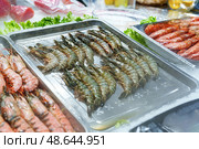 Fresh seafood displayed at a market stall during midday in a coastal town. Стоковое фото, фотограф Сергей Толмачёв / Фотобанк Лори