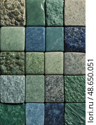 Arranged tiles showcasing the unique colors and textures of amazonite, a bluish green potassium feldspar, captured in an artistic display. Each piece highlights natural beauty Generative AI. Стоковое AI-изображение, AI-художник Юлия Петровская / Фотобанк Лори