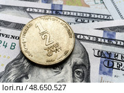Close-up of a Israel shekel coin on US 100 dollar bills in focus. Стоковое фото, фотограф Емельянов Евгений Викторович / Фотобанк Лори