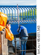 Kronstadt, Russia. June 11, 2015. Surveyors measure sea level. From the zero point of the Kronstadt footpost, measurements of the depth of the Baltic Sea and absolute heights are made throughout Russia. Редакционное фото, фотограф Оксана Медведева / Фотобанк Лори