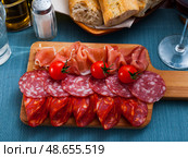 Top view of sliced Spanish dry-cured gammon and sausages. Стоковое фото, фотограф Яков Филимонов / Фотобанк Лори