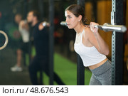 Sporty girl performing exercises with barbell during intense workout. Стоковое фото, фотограф Яков Филимонов / Фотобанк Лори