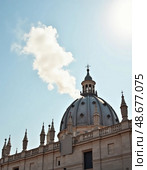 A swirling plume of white smoke escapes from the Sistine Chapel, signaling the election of a new pope. The bright sky enhances the historic moment above Vatican City Generative AI. Стоковое AI-изображение, AI-художник Юлия Петровская / Фотобанк Лори