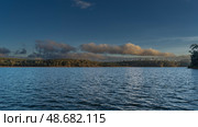 Beautiful calm blue lake. Ripples on the surface of the water. Green vegetation on the hilly shores. Clouds in the sky. Copy space. Evening light. Madagascar. Lake Mantasoa. Стоковое фото, фотограф Вера Ивановна Кубарева / Фотобанк Лори