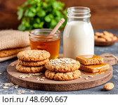 There is fresh milk, oatmeal cookies and honey on the table. Morning breakfast. Still life. Стоковое AI-изображение, AI-художник Сергей Елизарьев / Фотобанк Лори