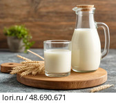 There is a glass of fresh milk on the table. Morning breakfast. Natural and environmentally friendly product. Still life. Стоковое AI-изображение, AI-художник Сергей Елизарьев / Фотобанк Лори