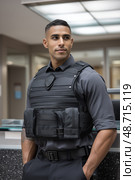 Security guard wearing bulletproof vest looking away. Стоковое AI-изображение, AI-художник Юрий Поздников / Фотобанк Лори