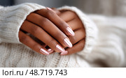 Elegant Close-Up of Manicured Hands Showcasing Shimmery Pink Nails Against a Cozy Sweater Backdrop. Стоковое AI-изображение, AI-художник Юлия Гапеенко / Фотобанк Лори