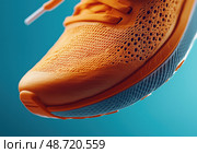 Спортивный оранжевый кроссовок крупным планом. Стоковое AI-изображение, AI-художник Александр Жуков / Фотобанк Лори
