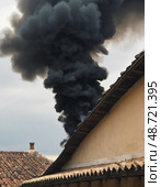 Dark clouds of smoke billow into the sky above the Sistine Chapel as onlookers await the announcement of a new pope, creating a dramatic and tense atmosphere in Vatican City Generative AI. Стоковое AI-изображение, AI-художник Юлия Петровская / Фотобанк Лори