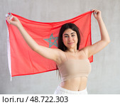 Happy young woman with flag of Monaco against unicoloured background. Стоковое фото, фотограф Яков Филимонов / Фотобанк Лори