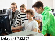 Teenagers studying with female teacher in information technology class. Стоковое фото, фотограф Яков Филимонов / Фотобанк Лори