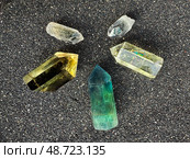 Colorful Quartz Crystals Set on Black Sand Background. Стоковое фото, фотограф Аnna Ivanova / Фотобанк Лори