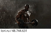 A muscular man lifts a barbell as rain pours down, showcasing his dedication and strength during an evening workout session. Стоковое AI-изображение, AI-художник Данила Большаков / Фотобанк Лори