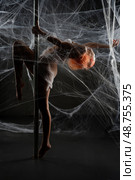 Red woman entangled in a net trap while posing in a web-like setting. Стоковое фото, фотограф Гурьянов Андрей / Фотобанк Лори