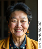 The elderly woman smiles warmly, her face a tapestry of experiences. Set against a cozy backdrop, her traditional attire and colorful earrings reflect cultural heritage and resilience Generative AI. Стоковое AI-изображение, AI-художник Юлия Петровская / Фотобанк Лори