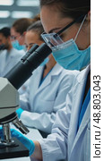 A pharmaceutical lab, scientists in lab coats analyzing samples under microscopes, with shelves of glass vials and sterile white laboratory outfits. Стоковое AI-видео, аниматор Sergey Grishin / Фотобанк Лори