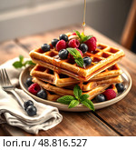 Belgian waffles with golden honey and fresh blueberries, raspberries and mint leaves on a rustic wooden table with a beautiful napkin. Delicious dessert. Copy space. Стоковое AI-изображение, AI-художник Iva Noel / Фотобанк Лори