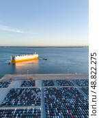 New Cars on Parking Lot and ro-ro Cargo Ship in Port of Setubal. Aerial View. Стоковое фото, фотограф Максим Забаровский / Фотобанк Лори