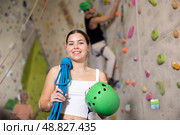 young positive muscular girl with necessary equipment stands in gym near climbing wall. Стоковое фото, фотограф Яков Филимонов / Фотобанк Лори