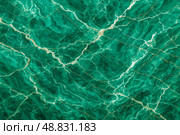 Deep emerald green marble surface featuring bold white and gold vein patterns offering luxurious backdrop for premium interior design applications decorative projects. Стоковое фото, фотограф Павел Муравьев / Фотобанк Лори