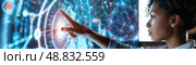 A young woman with curly hair focuses on a digital display, interacting with its glowing interface. The complex data and patterns give off a futuristic feel. Стоковое AI-изображение, AI-художник Данила Большаков / Фотобанк Лори