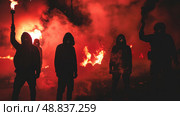 Silhouettes of five people stand against a backdrop of red smoke and flames, their faces obscured. Стоковое AI-изображение, AI-художник Данила Большаков / Фотобанк Лори