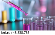 Laboratory experiment with pipette and colorful test tubes showing science in action. Стоковое AI-изображение, AI-художник Сергей Толмачёв / Фотобанк Лори