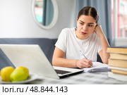 Young student girl writes an abstract in a copybook. Стоковое фото, фотограф Яков Филимонов / Фотобанк Лори