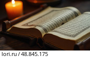 Candlelit Qur'an on a Wooden Stand, Open on Sacrifice, Facing the Camera; a Blend of Education, Spirituality, and Candle Shops. Стоковое AI-изображение, AI-художник Sergey Grishin / Фотобанк Лори
